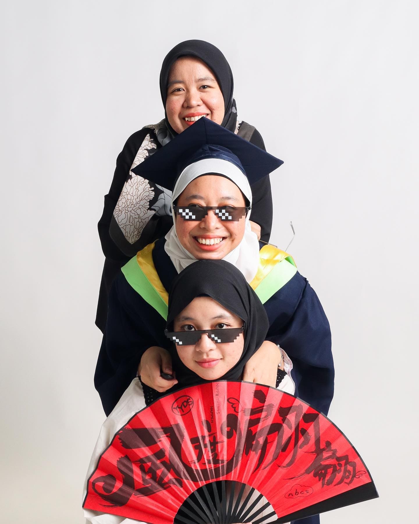 Malay family graduation photo with white background in photo studio