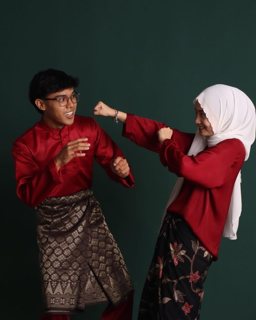 Malay couple funny fighting photo with dark green background in photo studio