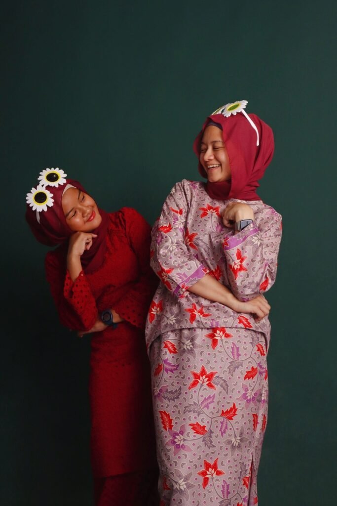 Malay sister photo funny with dark green background in photo studio