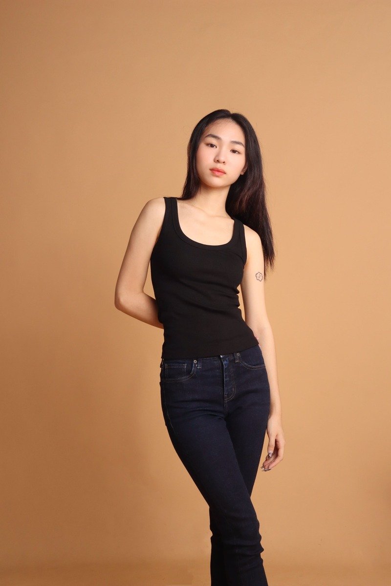 Girl portrait black outfit with khaki background